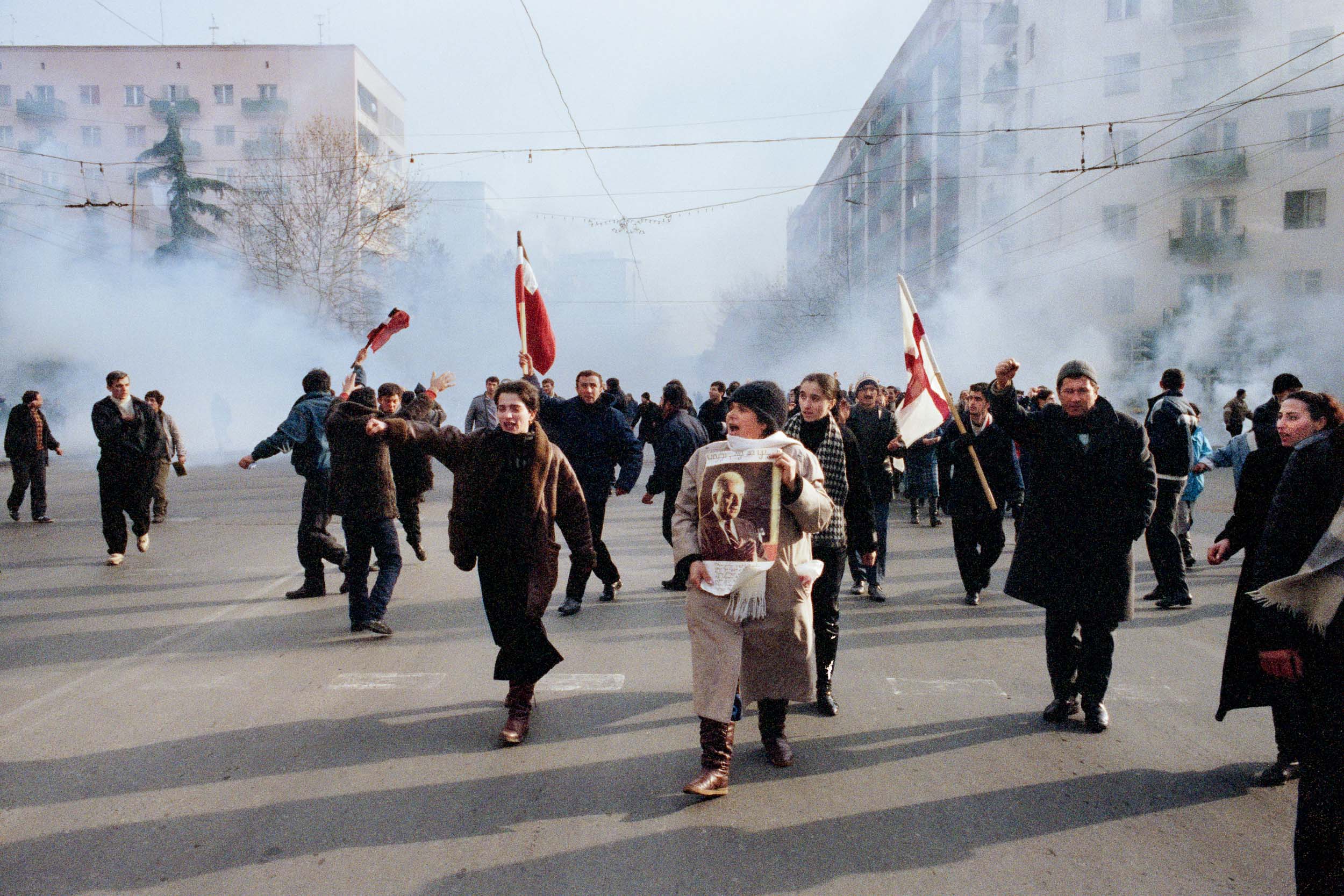 Despite smoke bombs, pro  Gamsakhurdia demonstrators march against the opposition. Tbilisi, Georgia
