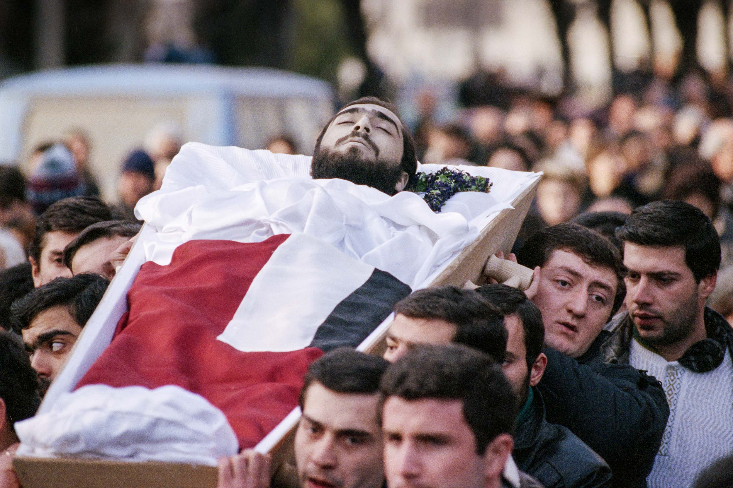 Pall bearers carry the body of  Levan Tactakichvili through the streets in a funeral procession to the cemetery for his burial, Tbilisi, Georgia