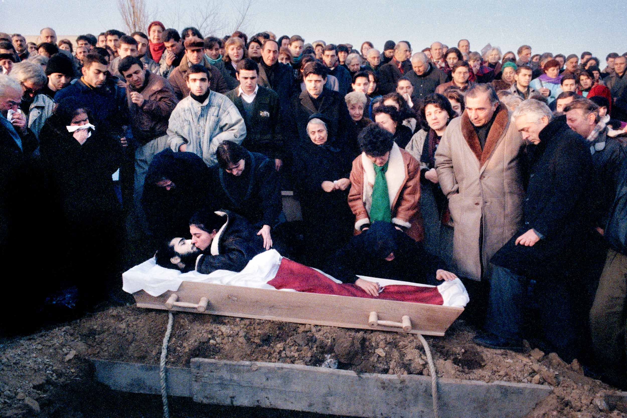 The wife  of  Levan Tactakichvili gives him his last kiss at the graveside. Tbilisi, Georgia