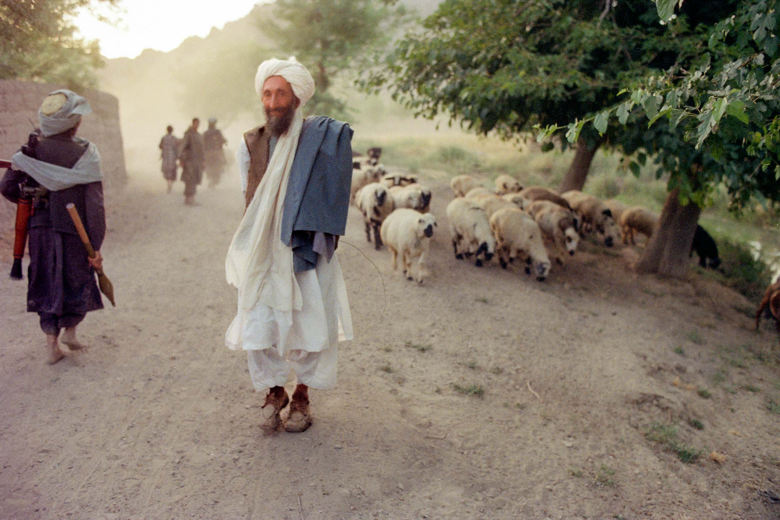 Mujahideen pass a shepard,in the suburbs of Kandahar, Afghanistan 1988