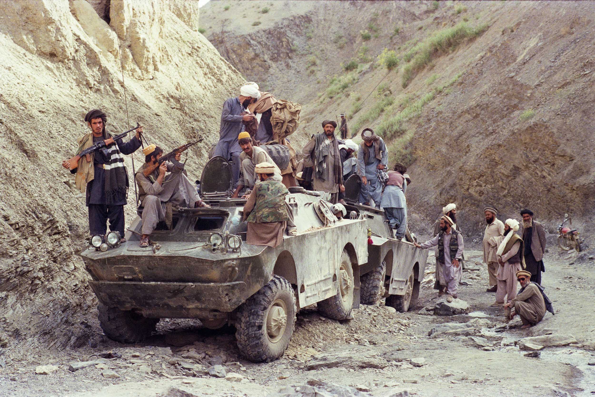 Mujahideen inspect surrendered military equipment in a gorge,  Afghanistan 1988