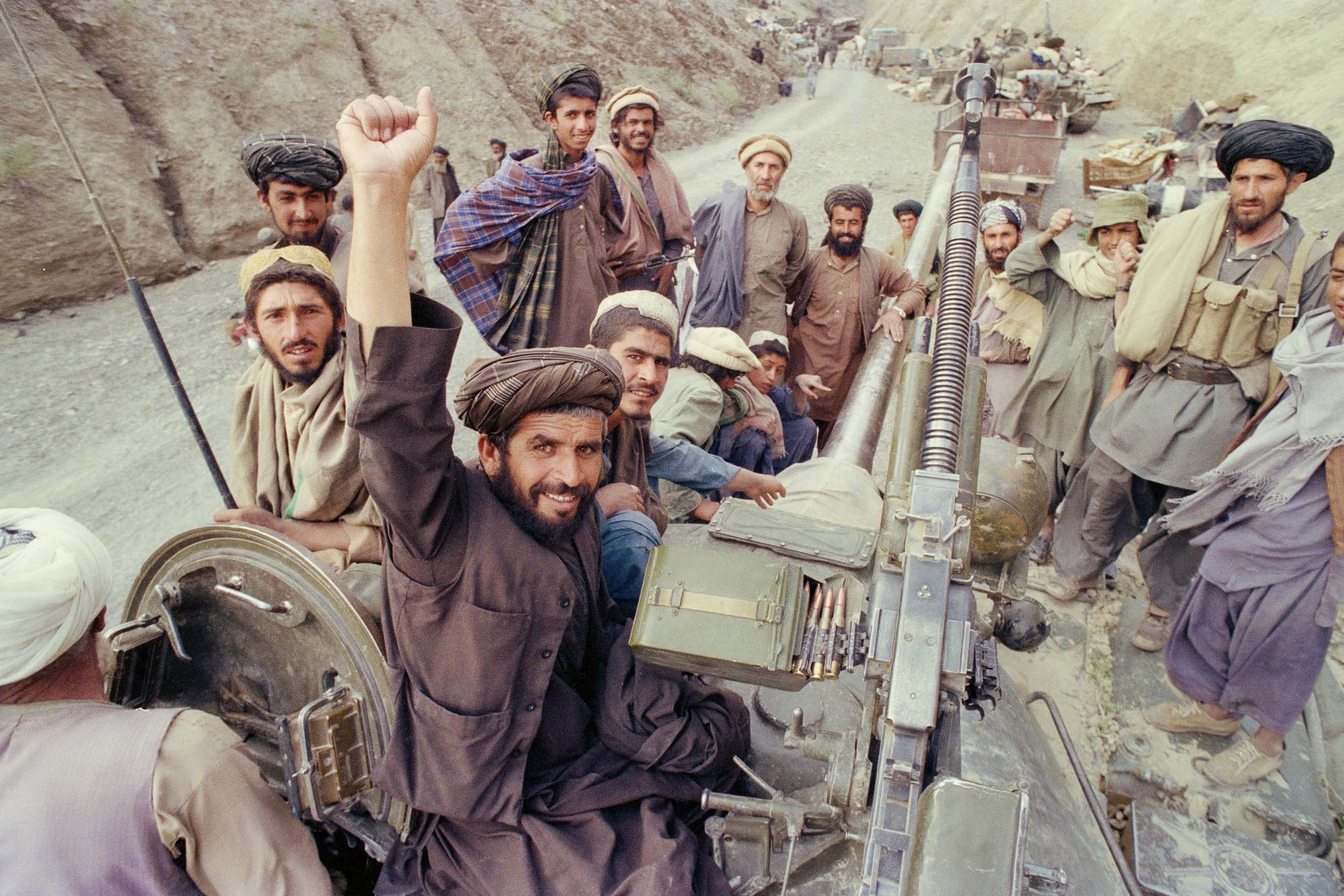 Mujahideen celebrate surrendered military equipment in a gorge,  Afghanistan 1988