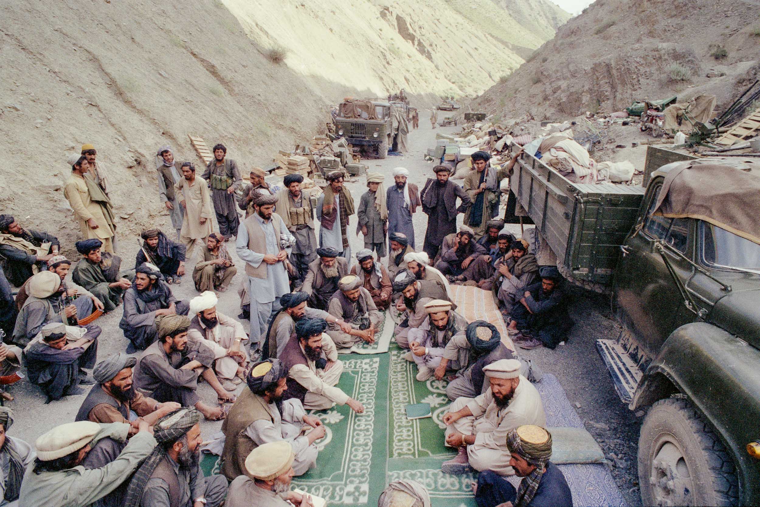 Mujahideen from different factions, discuss dividing  surrendered military equipment,  Afghanistan 1988