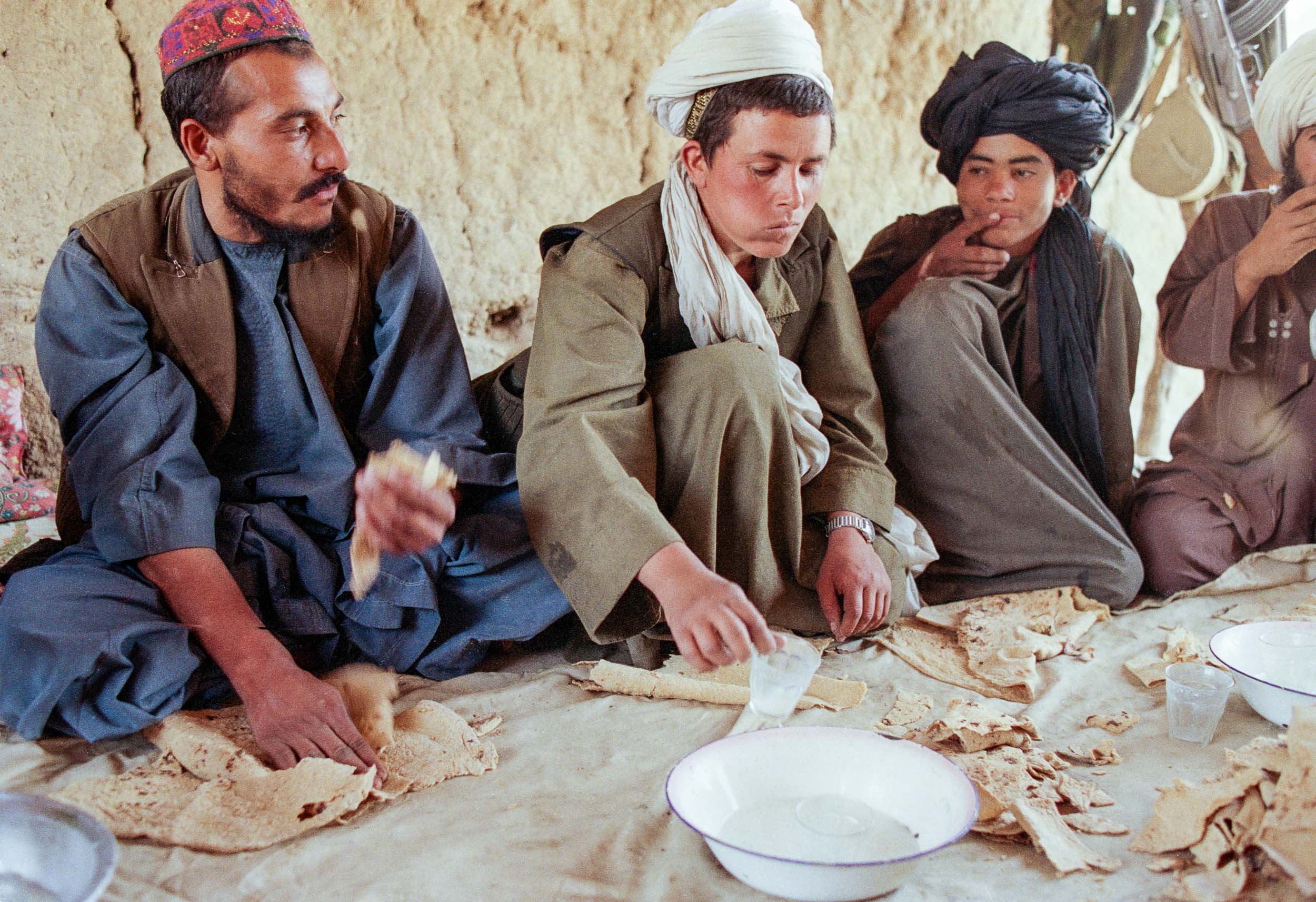  Mujahideen eat bread and lamb soup  in camp, Afghanistan 1988 