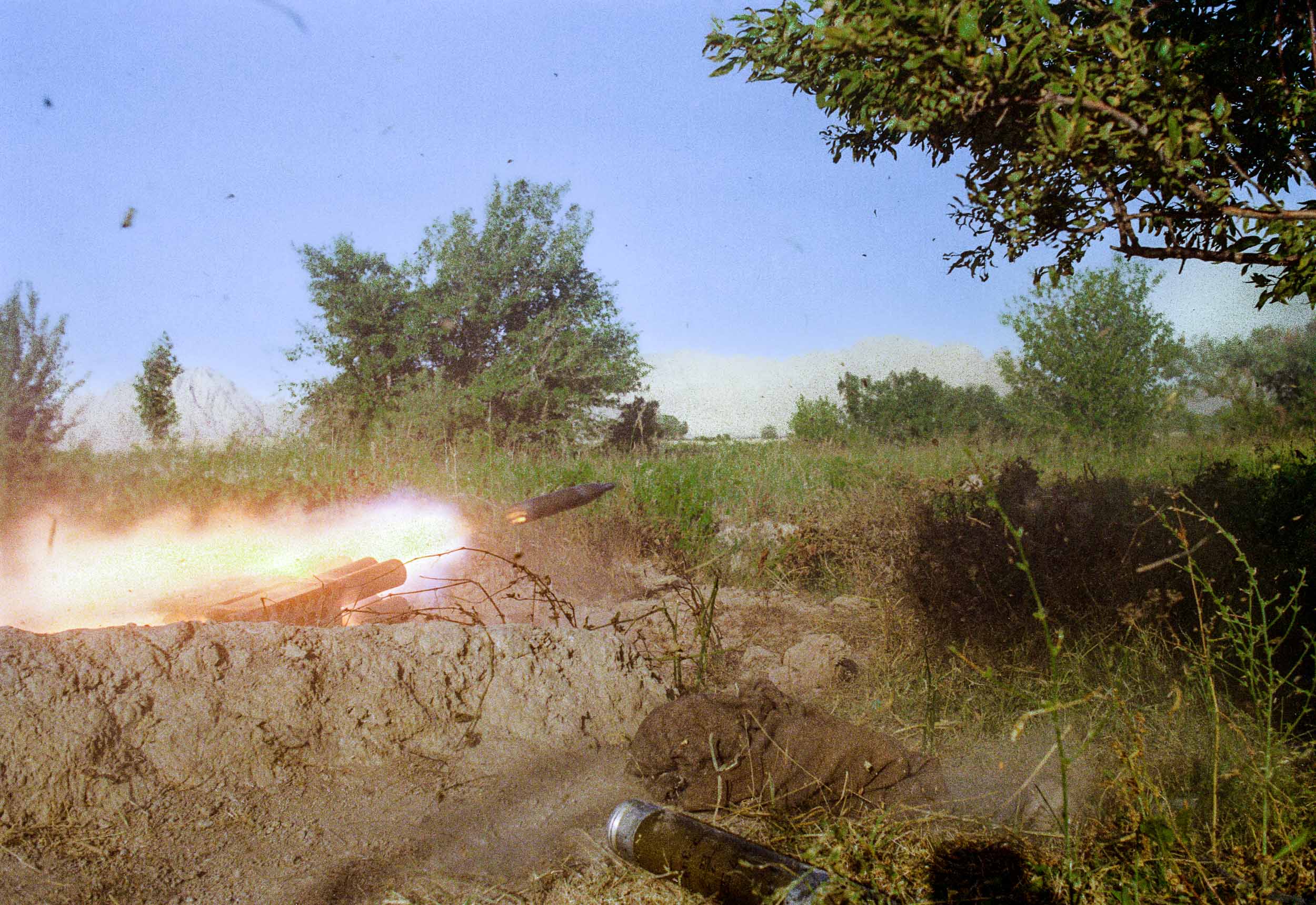 Mujahideen fire a Chinese made  rocket launcher towards a Russian government post,  Afghanistan 1988