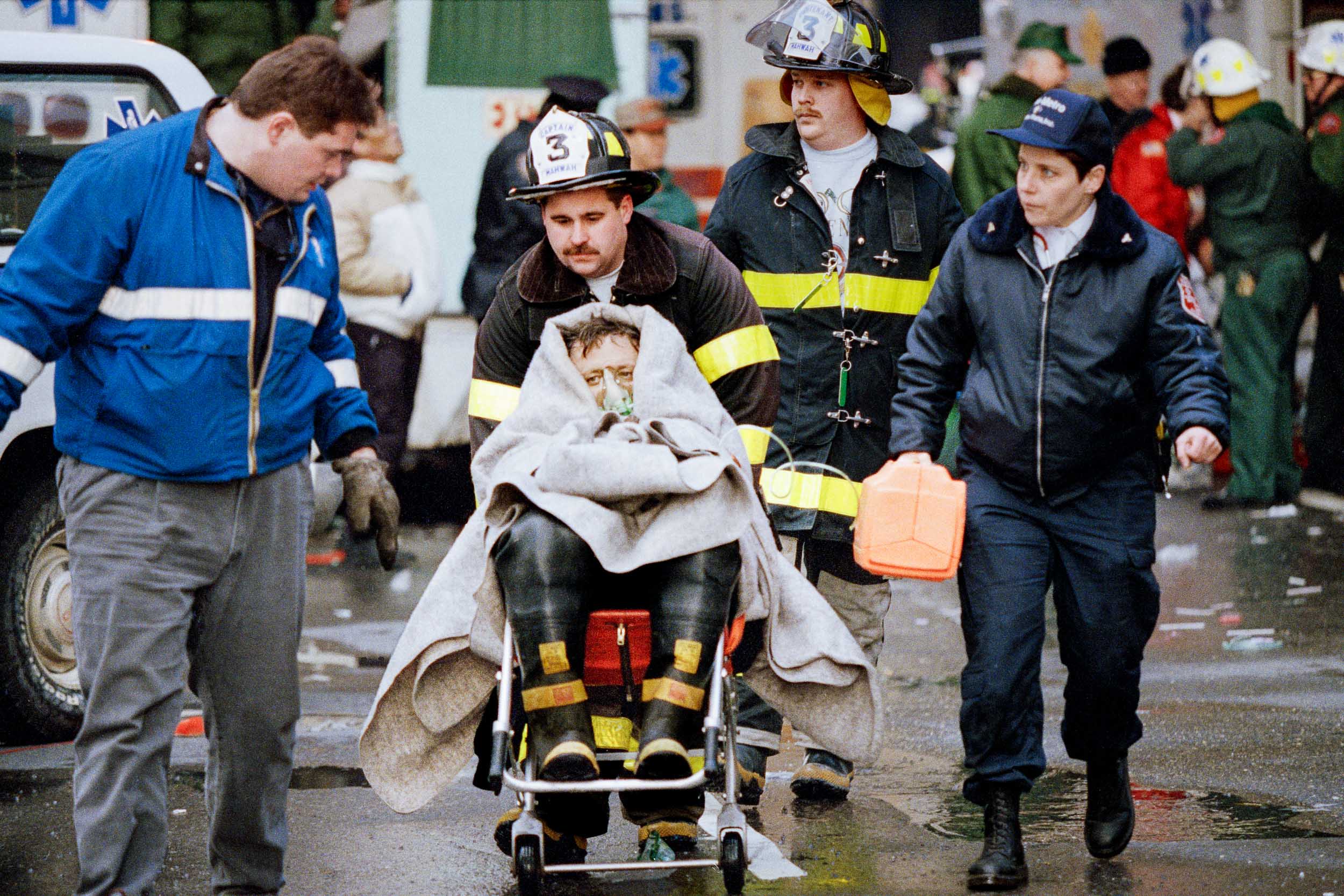 Injured fireman getting medical assistance outside of the World Trade Center, NY, 1993