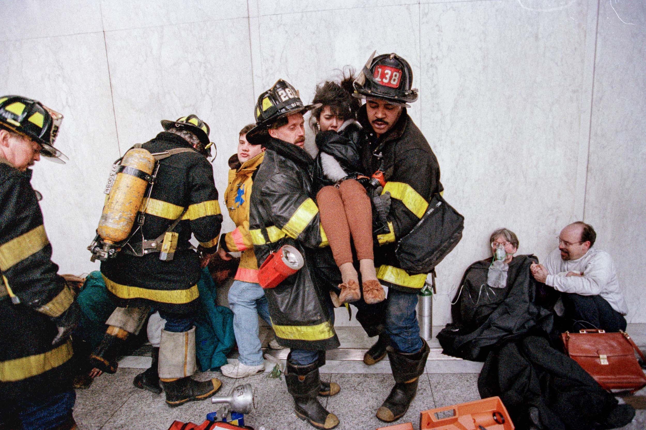 An office worker getting carried by 2 firemen in the lobby of the World Trade Center, NY, 1993