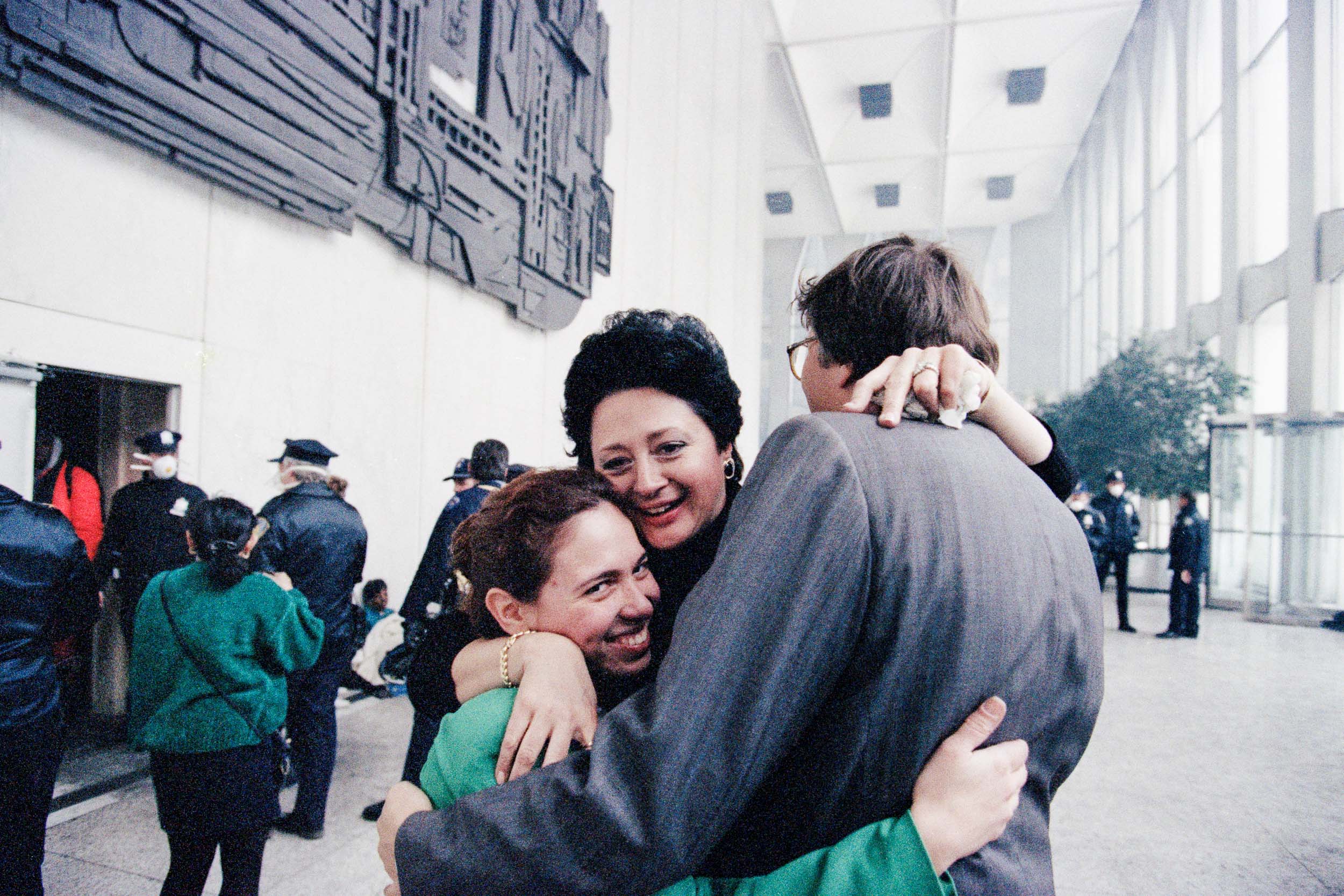 Office workers reuniting with joy  in the lobby of the World Trade Center, NY, 1993