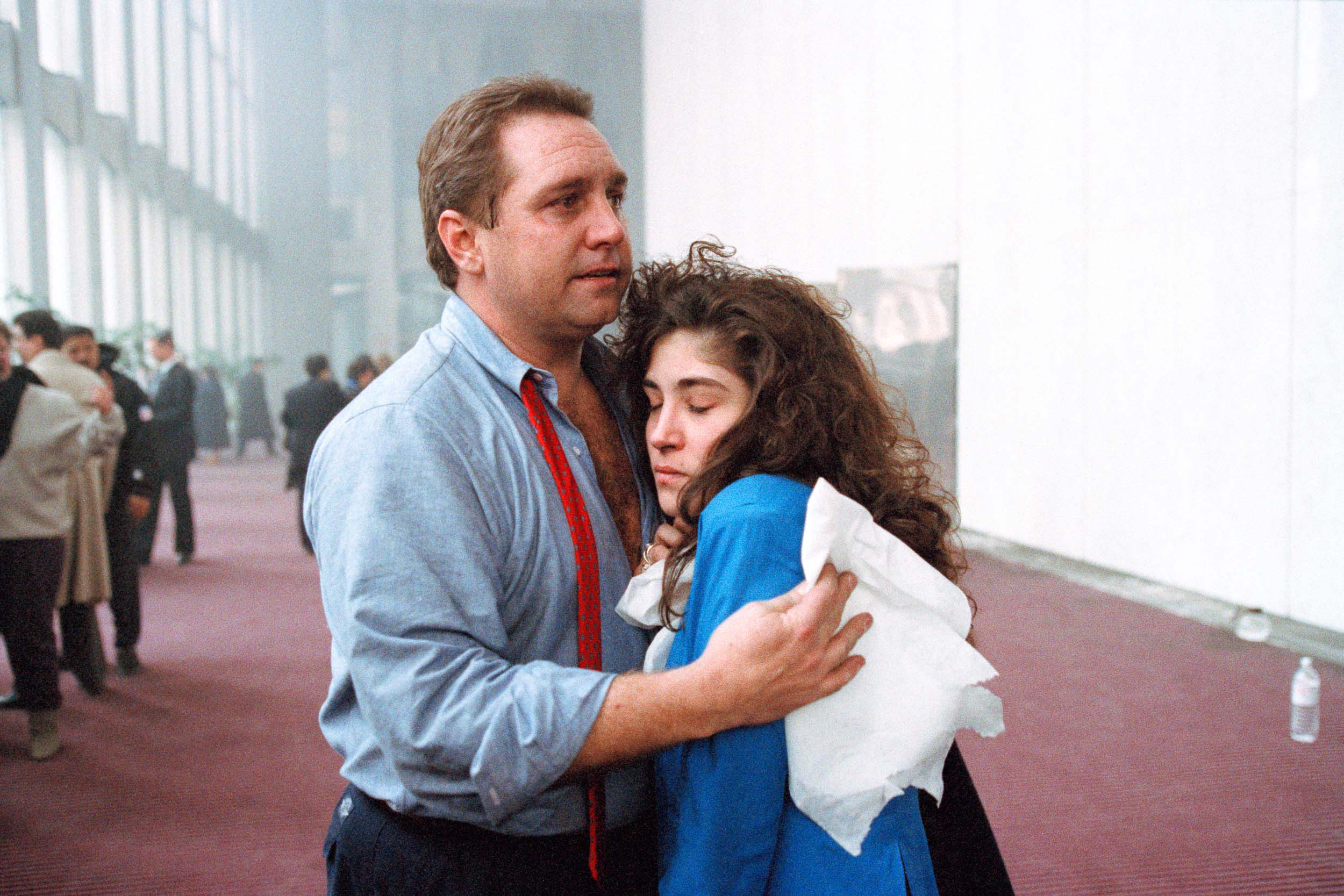 Office workers reuniting with relief  in the lobby of the World Trade Center, NY, 1993