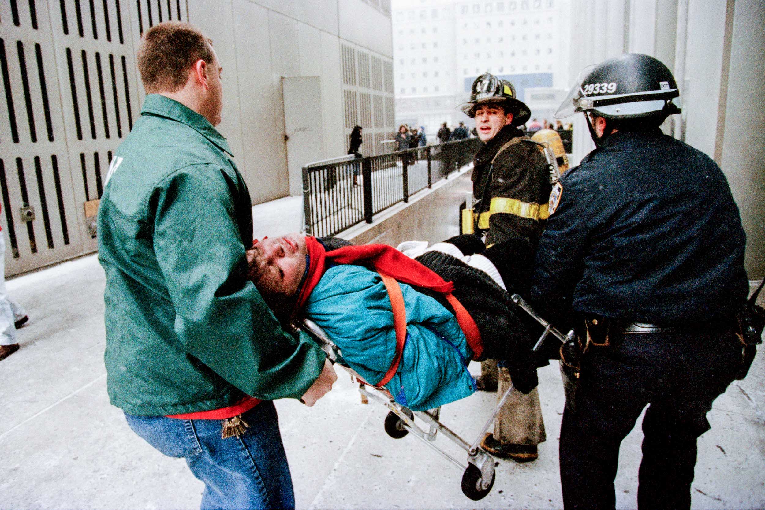  Firemen carry out an injured office worker down the steps of the World Trade Center, NY, 1993