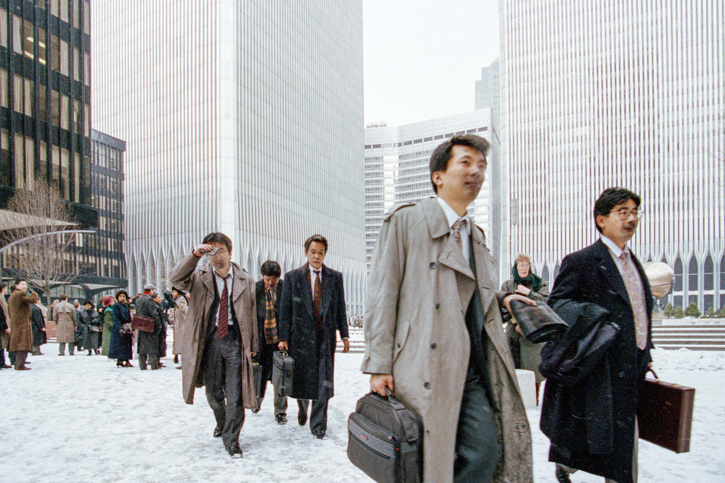 Stunned office workers walk away from the World Trade Center, NY, 1993